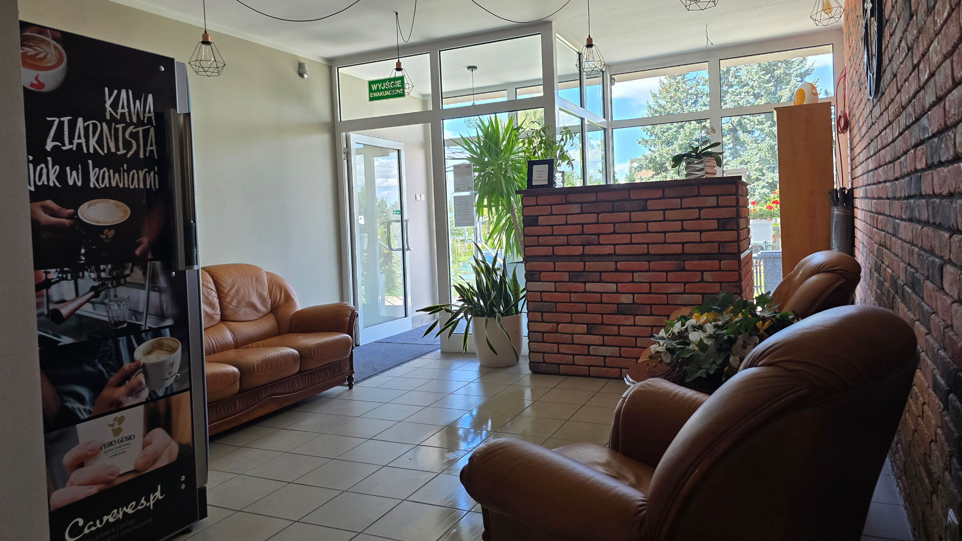 Recepcja hotelowa z ceglaną ladą i wygodnymi fotelami – Noclegi Gorzów w Baczynie